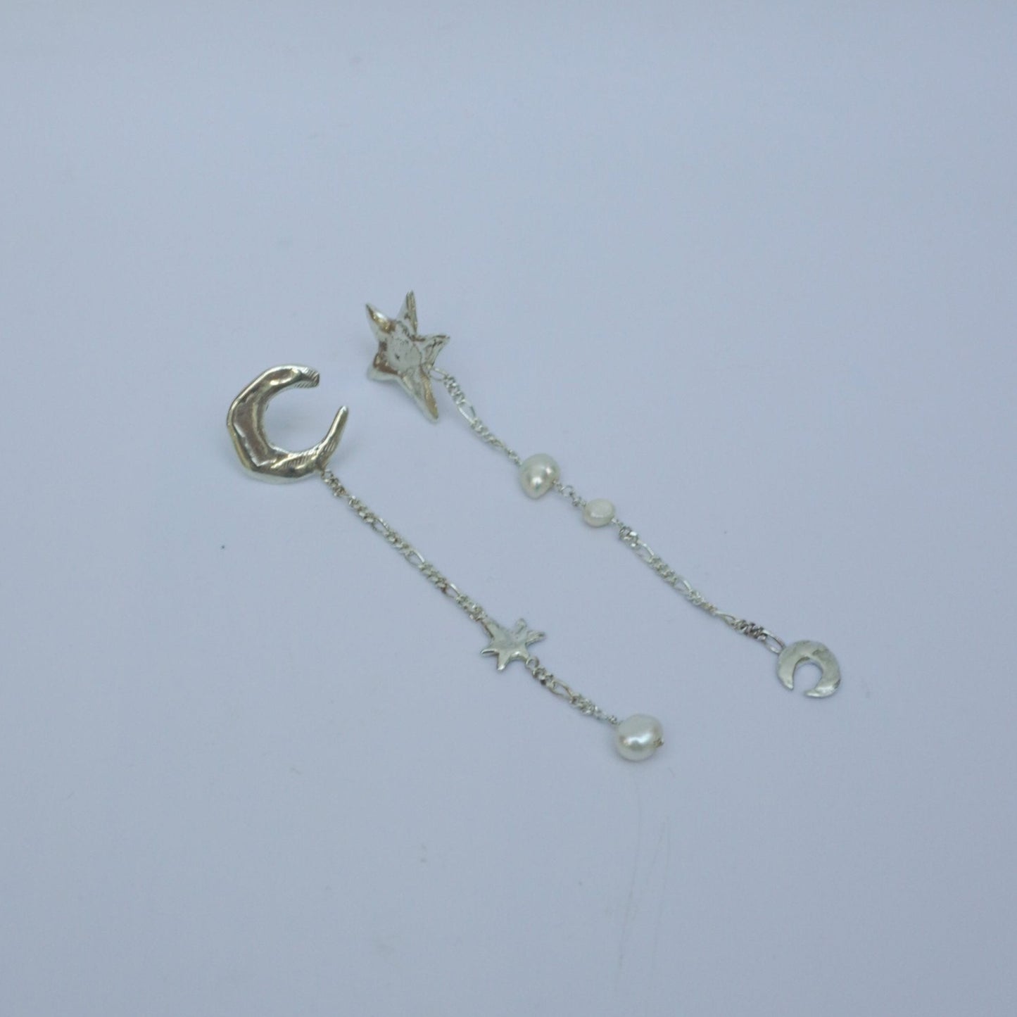 Asymmetric drop stud earrings with organic moon and star shapes and natural pearls, silver