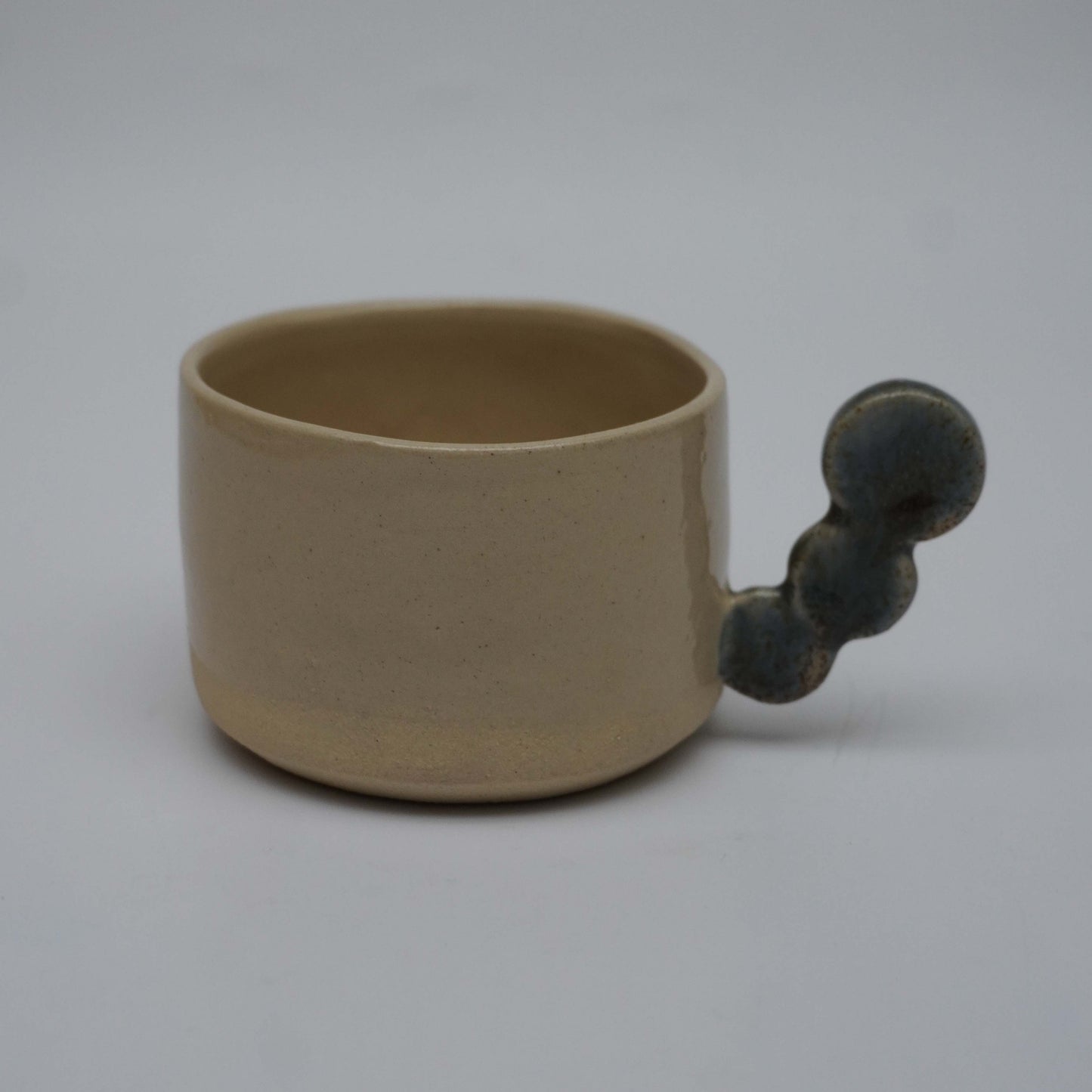 Beige espresso cup with dark dots handle