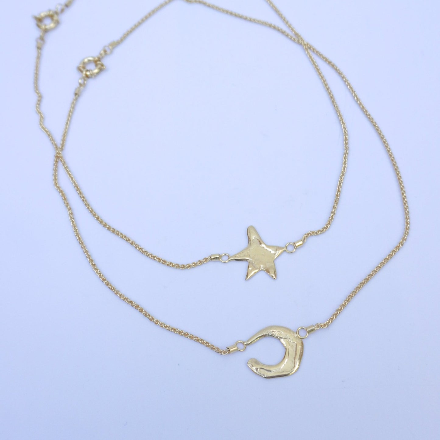 Cenere stellare gold-plated neckalaces with a moon, second with a star, gold-plated