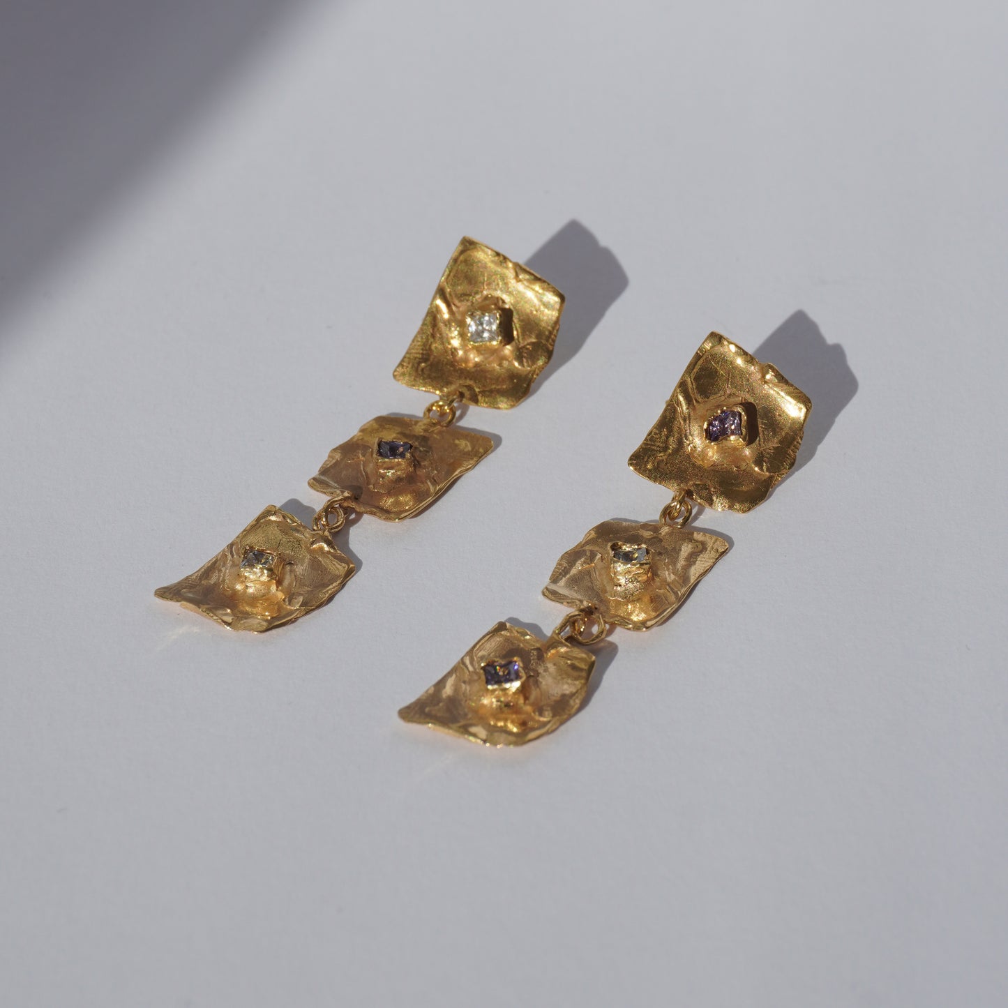Gold-plated handcrafted earrings with organic sculptural elements and hand-set gemstones