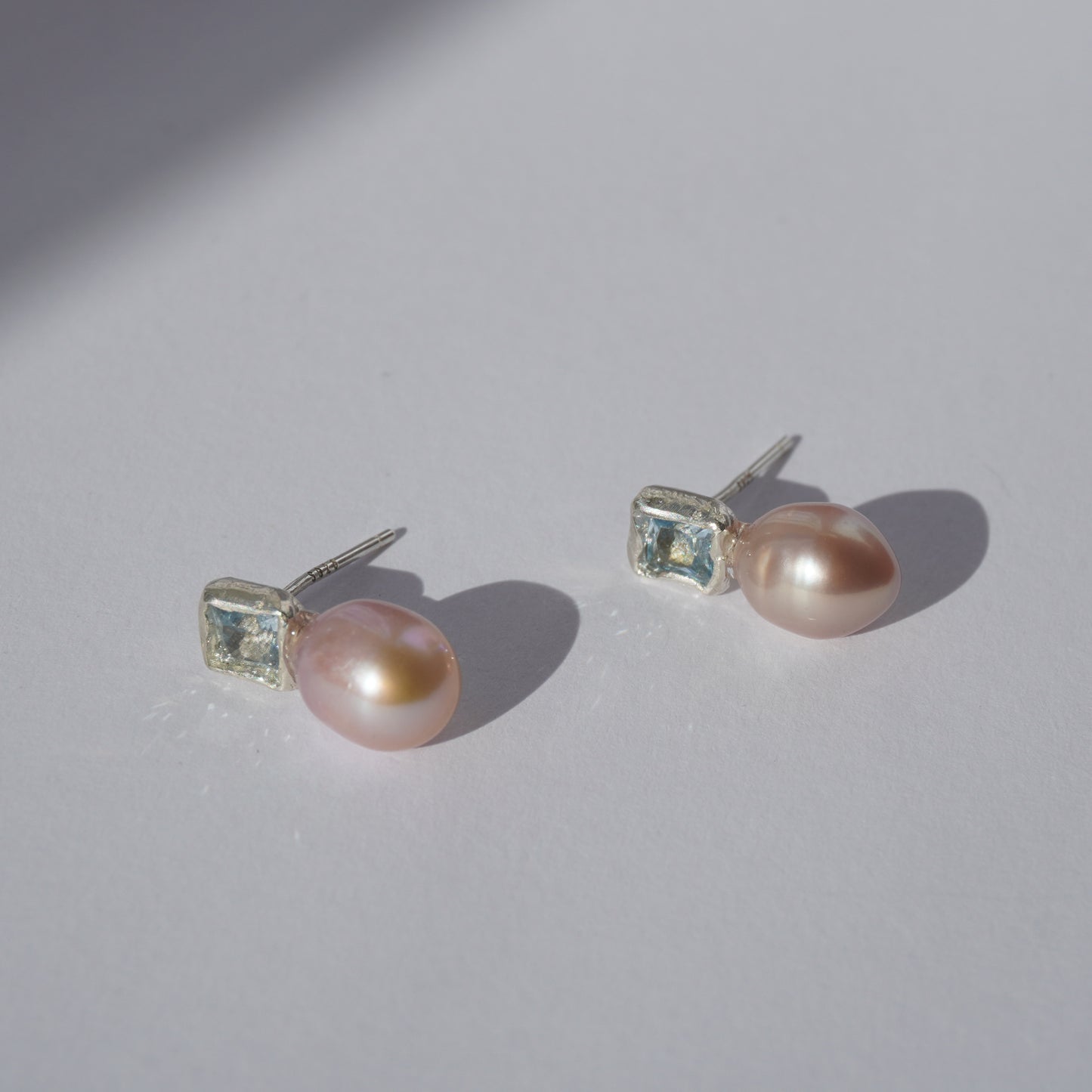 Handcrafted silver earrings with square light-blue gemstones and pink freshwater pearls