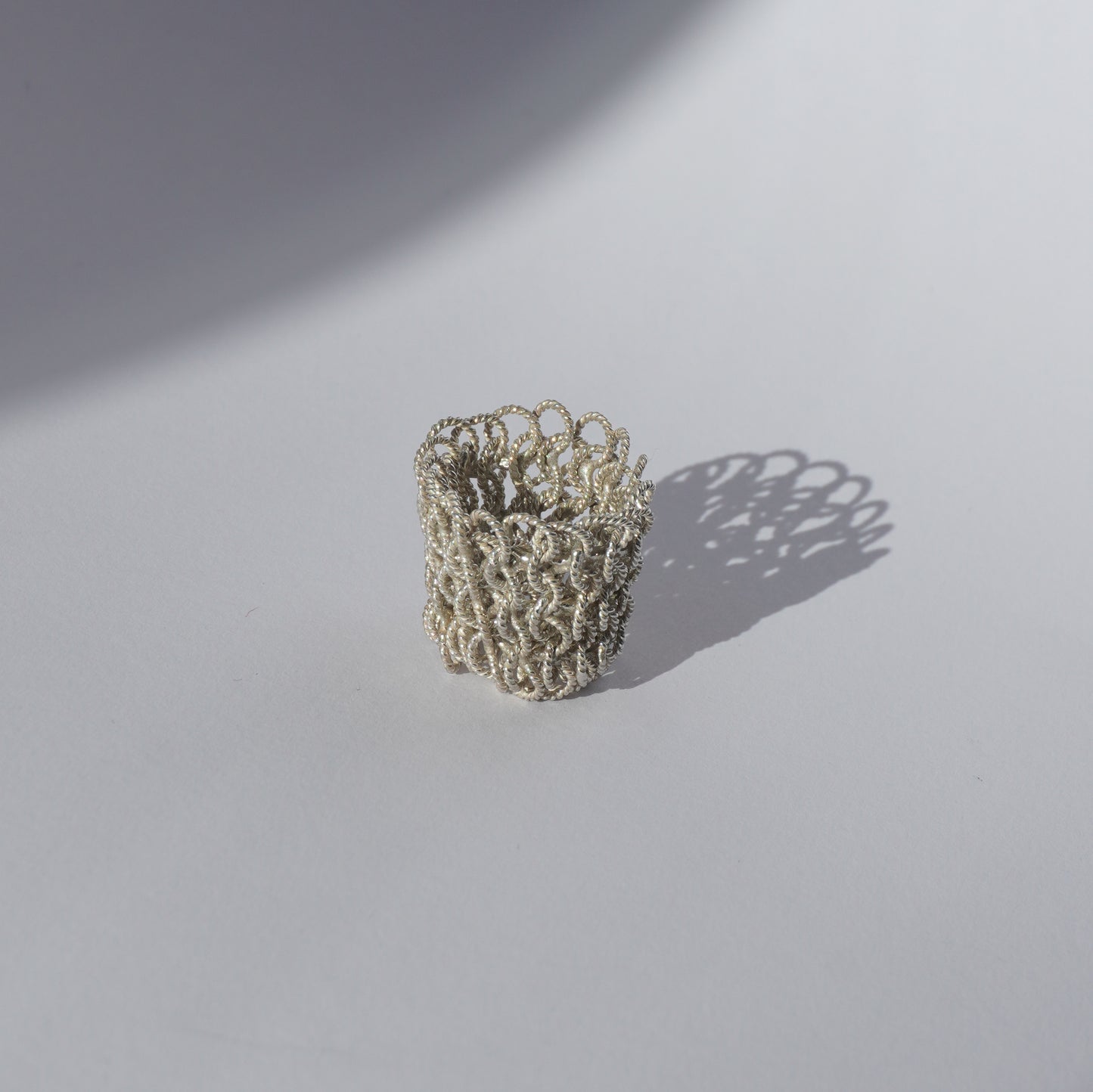 Handcrafted wide mesh ring made of interlinked twisted silver loops