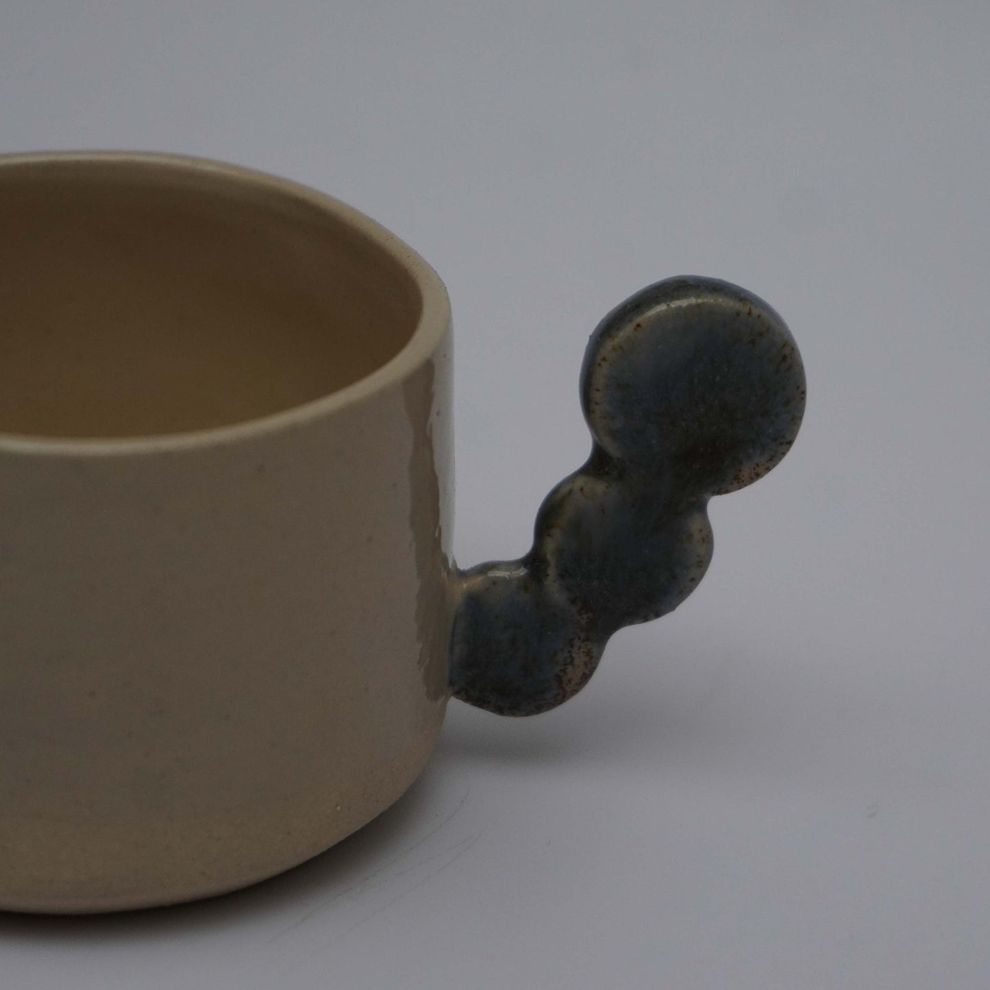 Beige espresso cup with dark dots handle