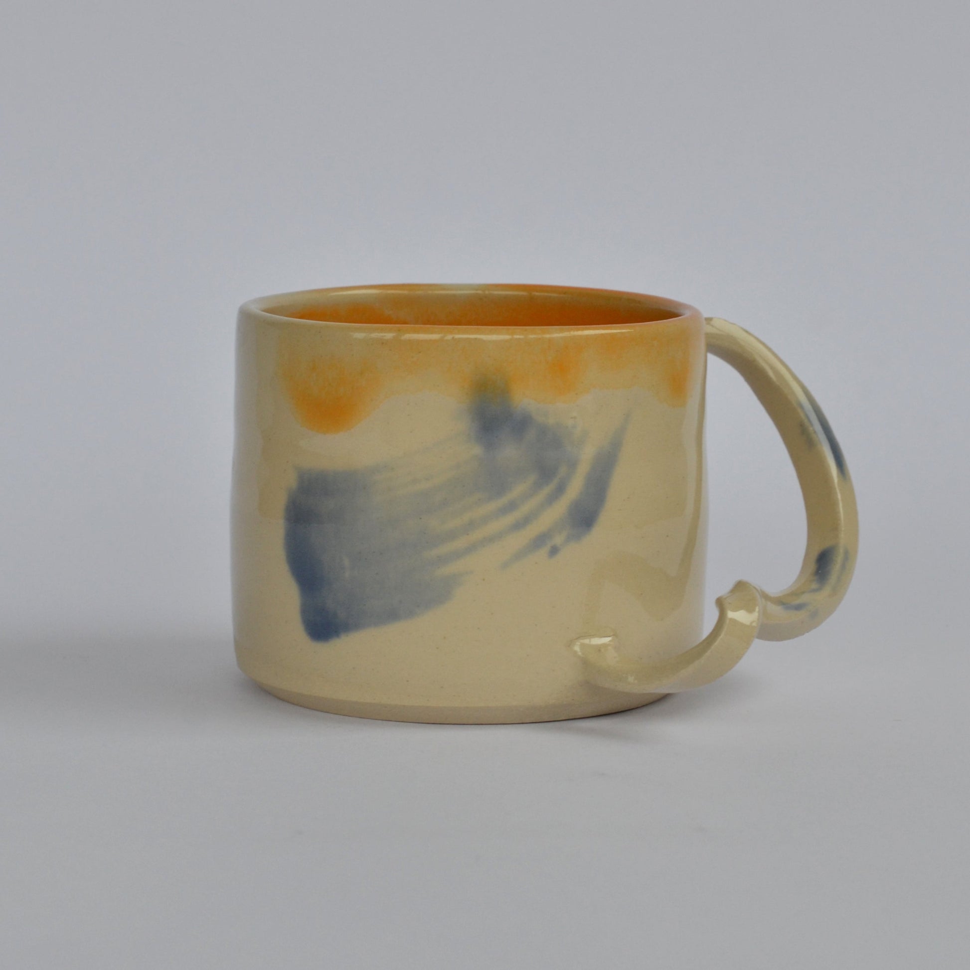 GIVE IT A TWIST handmade ceramics mug orange interior and blue brushes
