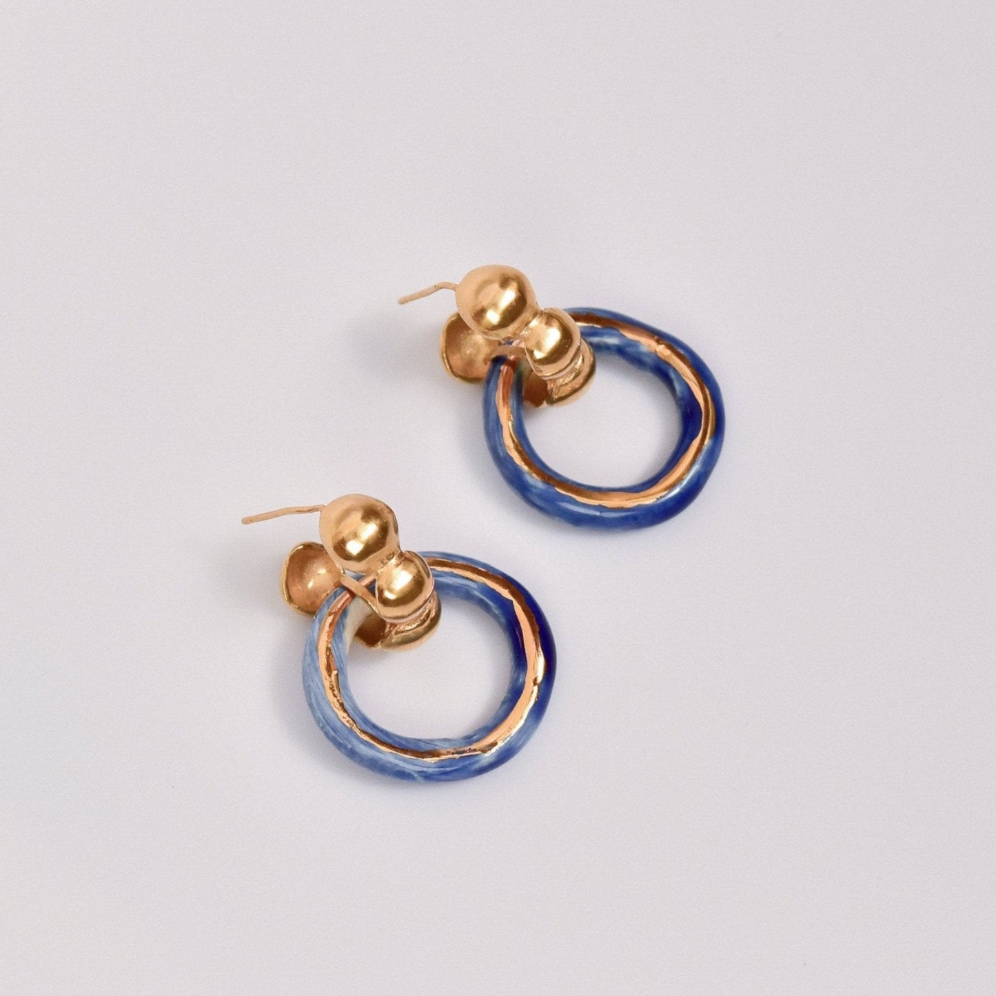 dancing digging deep earring blue gold luster hoop