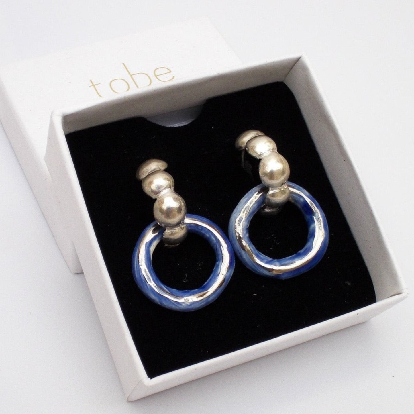 dancing digging deep earring blue hoop silver luster