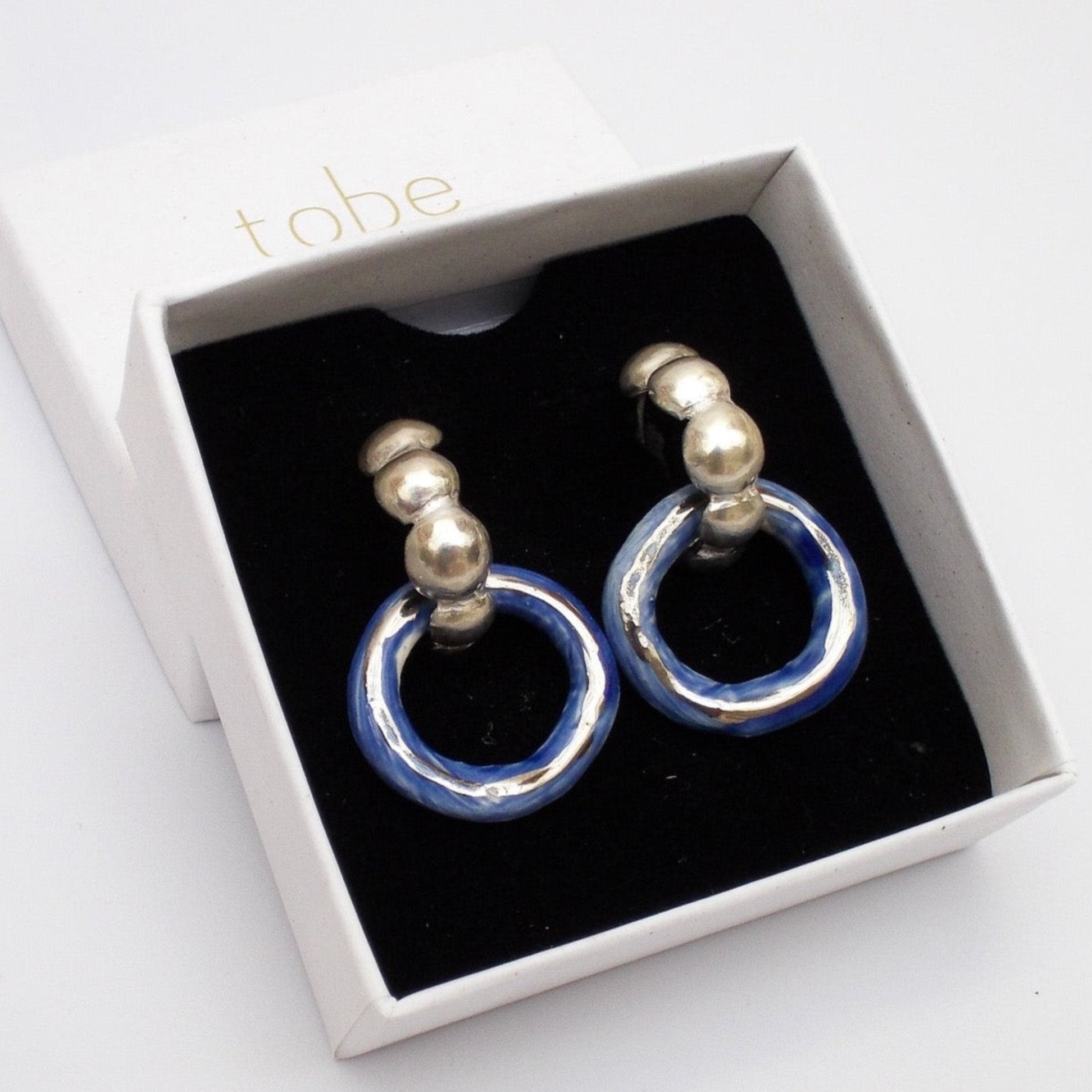 dancing digging deep earring blue hoop silver luster