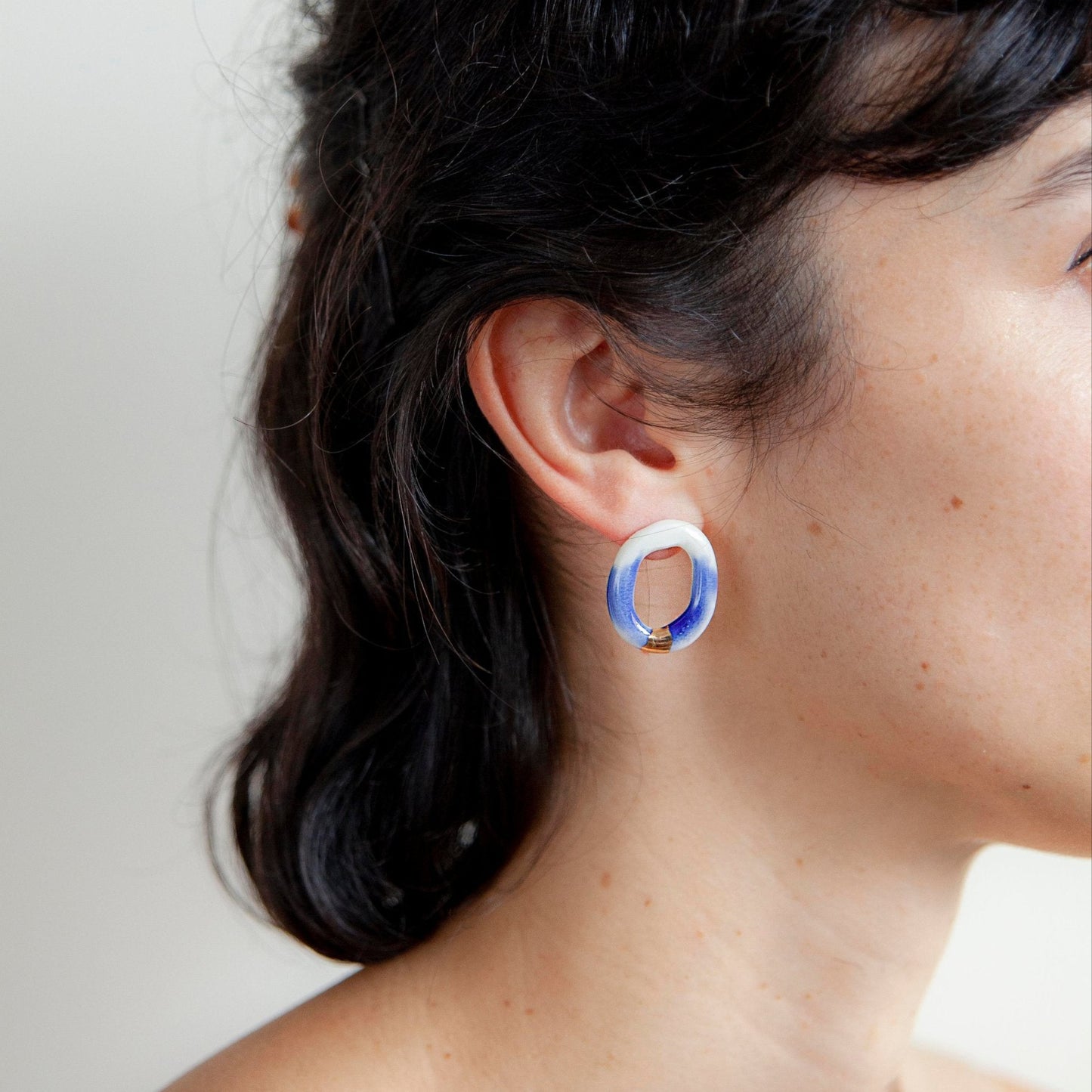 Artisanal Handmade Porcelain Earrings Porcelain Blue and White with Gold or Silver Detail. Lightweight Oval-Shaped Hoops That Blend Minimalist Elegance With a Bold, Contemporary Look. Perfect for Statement Jewelry Lovers Seeking Unique, Handcrafted Pieces.