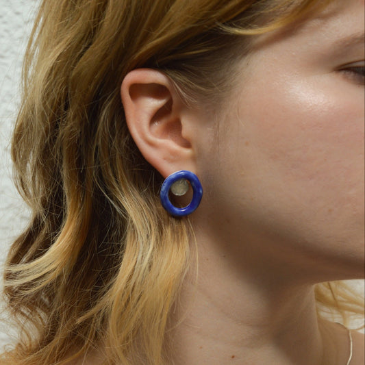 Artisanal handmade blue porcelain stud earrings with unique oval hoop design and hammered gold or silver detail. Lightweight and modern ceramic earrings, perfect for minimalist or statement jewelry styles. Ideal for everyday wear or as a thoughtful handmade gift.