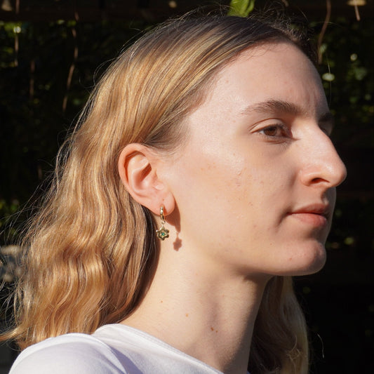 organic gold hoop earring with flower pendant