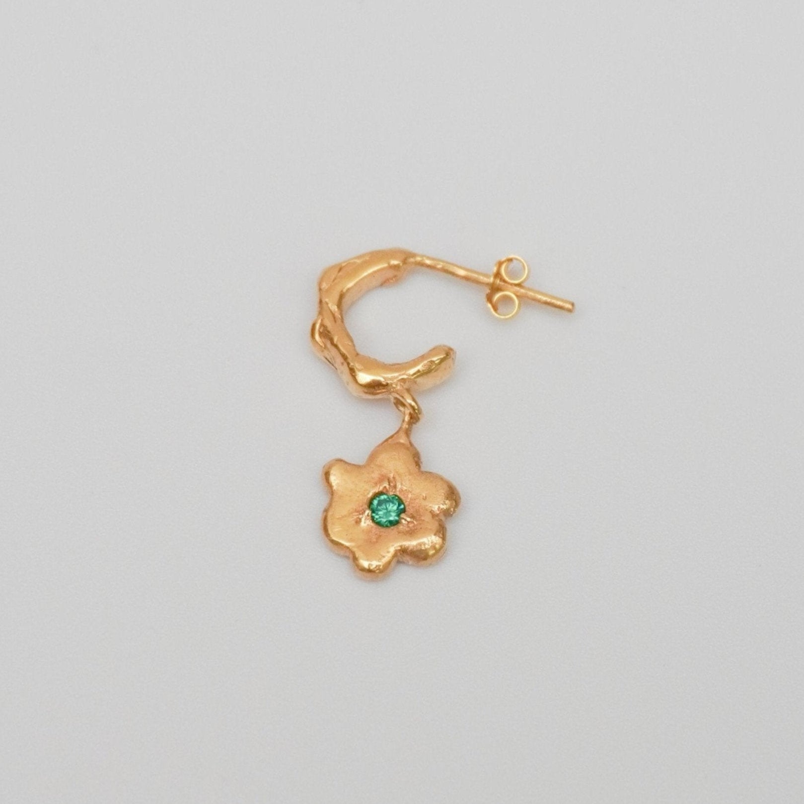 organic gold hoop earring with flower pendant