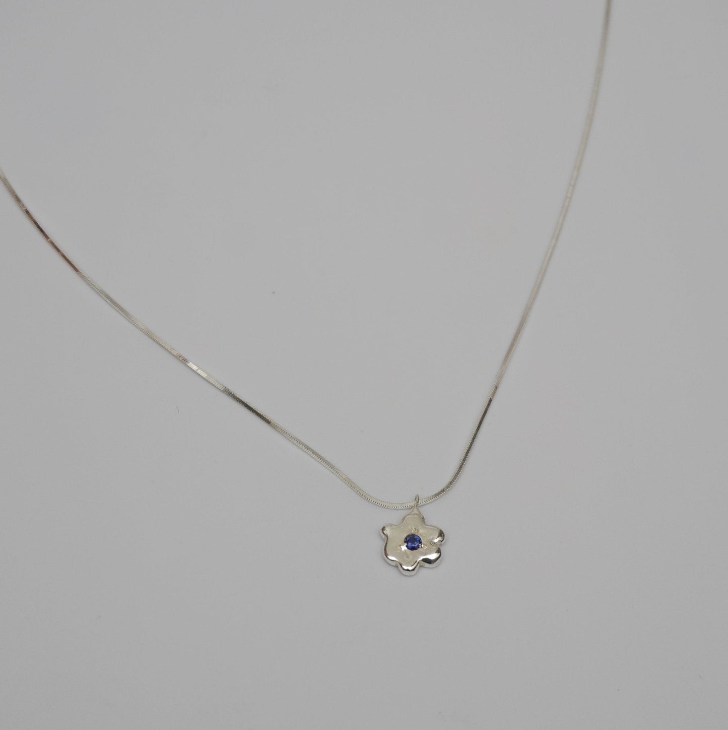 organic metal pendant necklace silver kindness flower blue stone