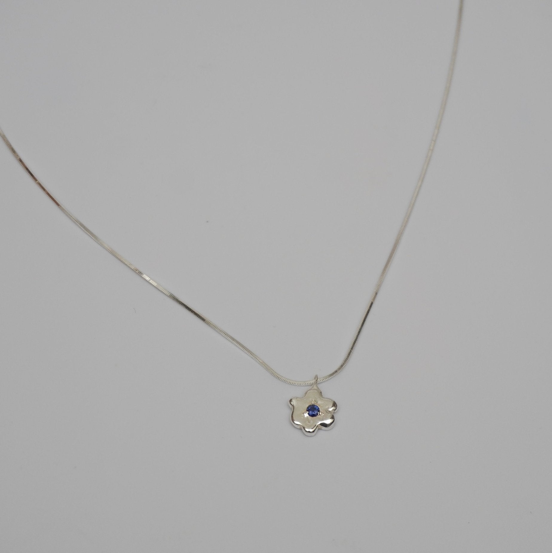 organic metal pendant necklace silver kindness flower blue stone