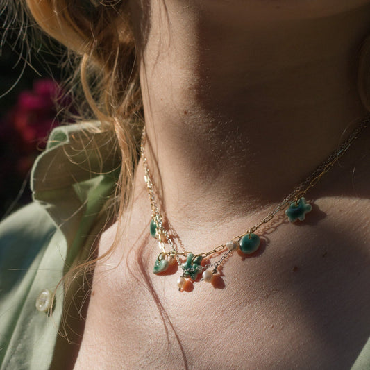 Gold plated chain with handmade porcelain green pendants.