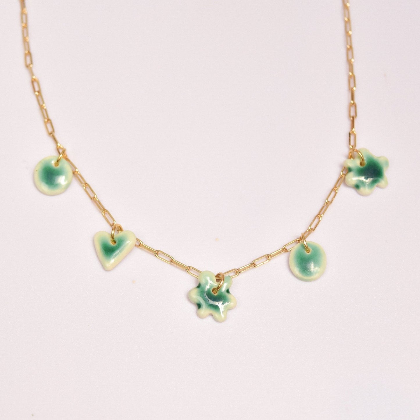Gold plated chain with handmade green porcelain pendants.