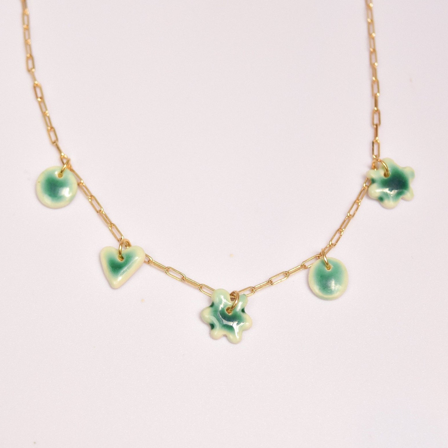 Gold plated chain with handmade green porcelain pendants.