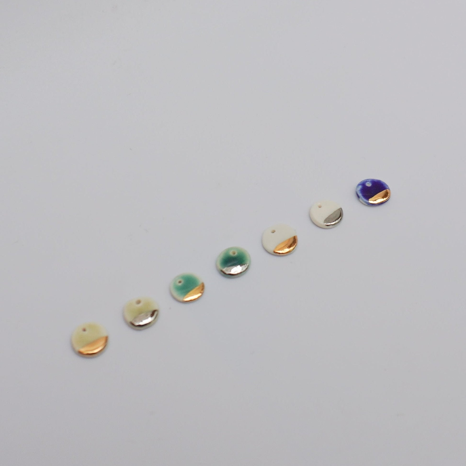 Porcelain pendants with silver/gold luster details