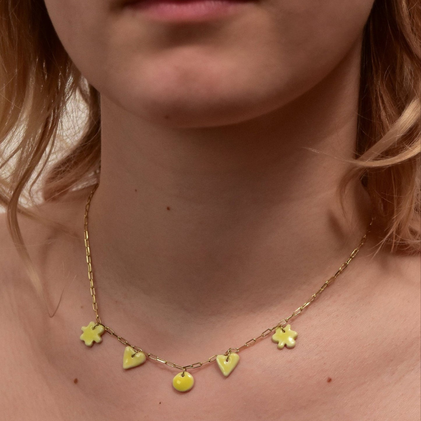 Gold plated chain with handmade yellow porcelain pendants.