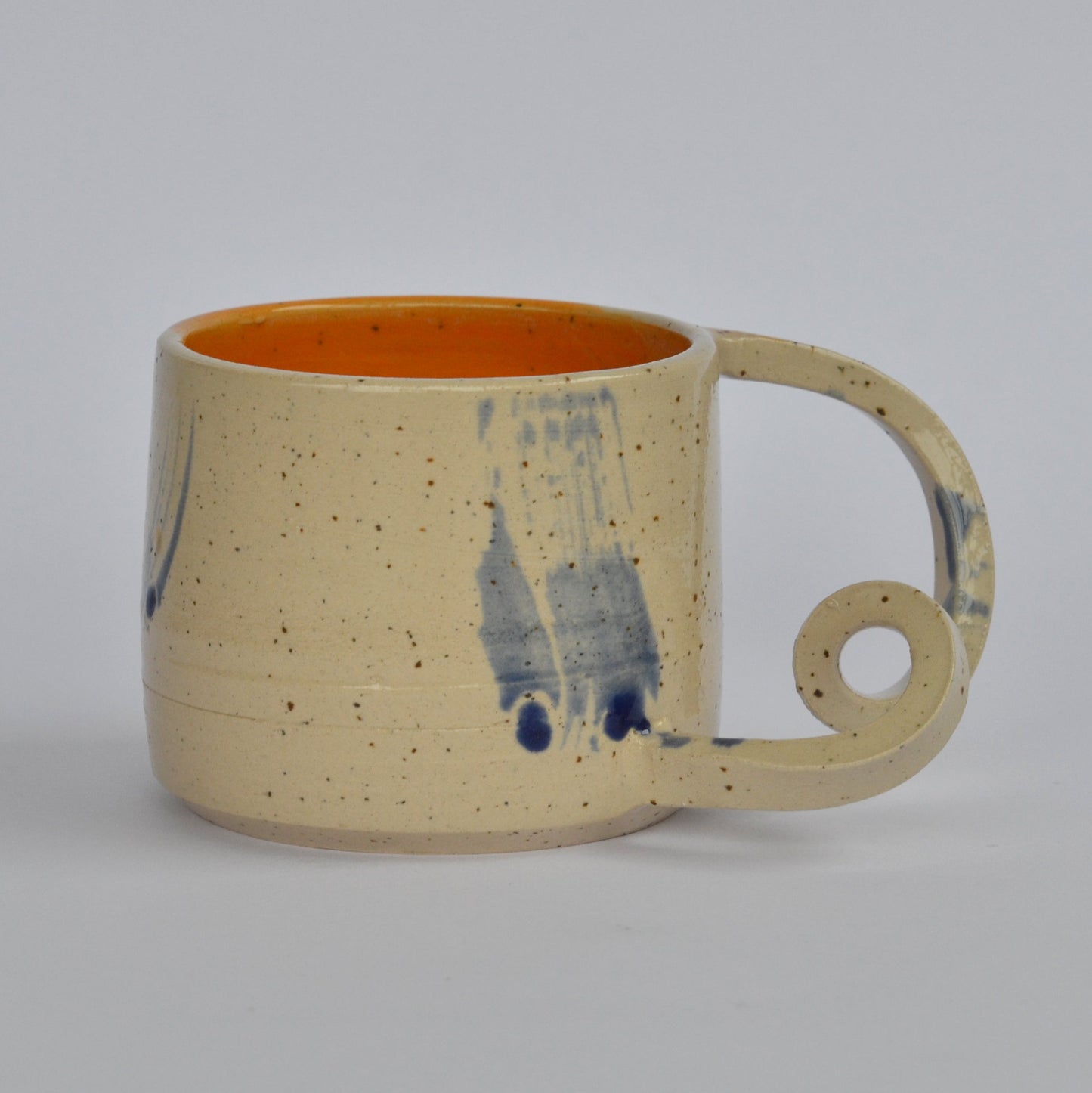 Handmade mug with a twisted handle for creative holding