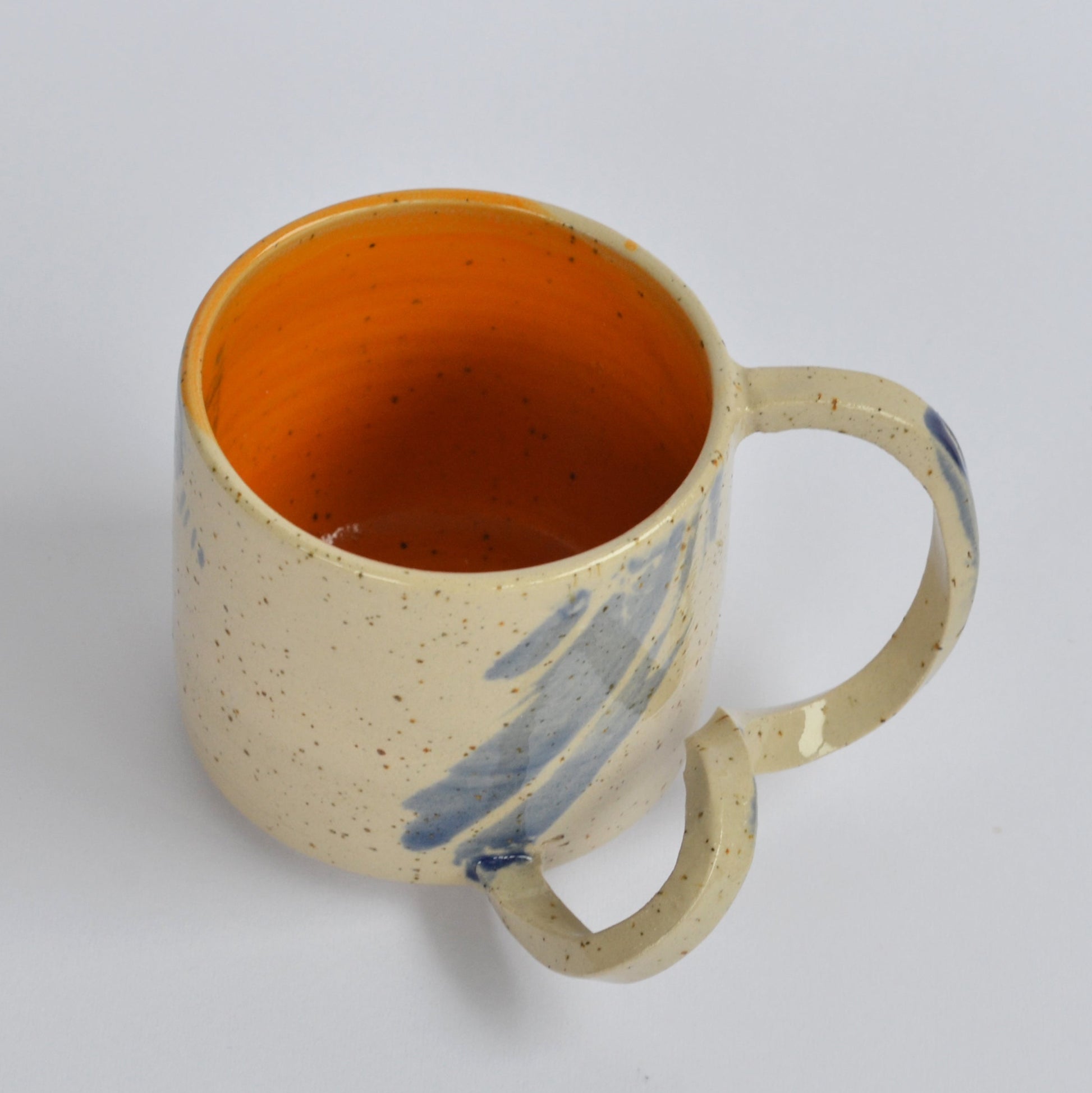 Handmade mug with a twisted handle for creative holding