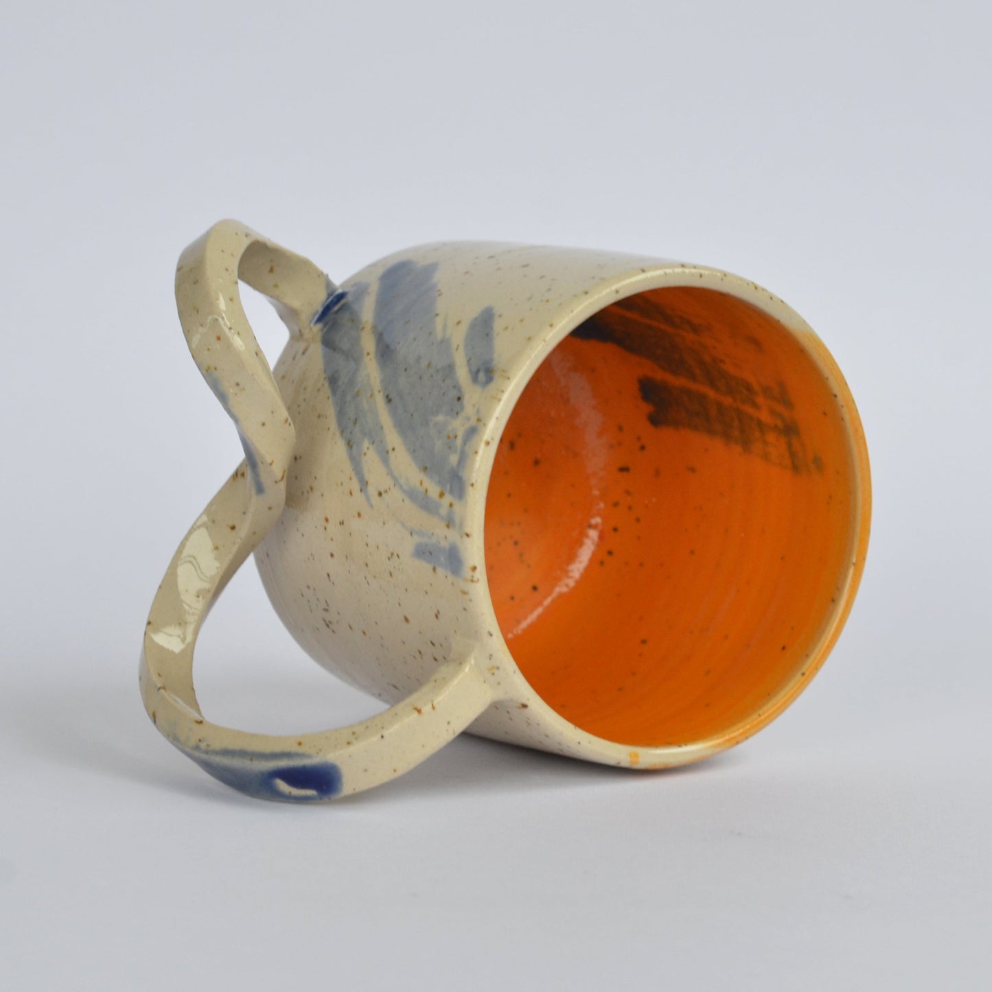 Handmade mug with a twisted handle for creative holding