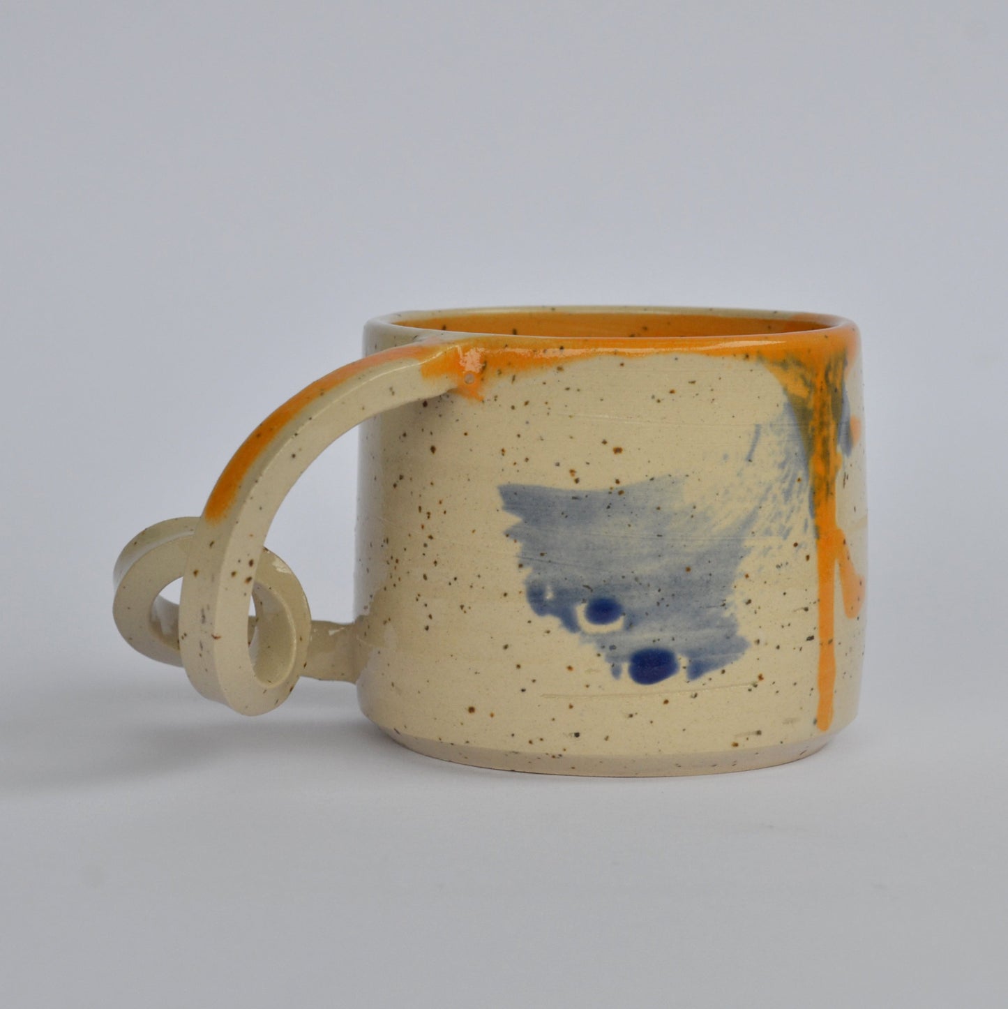 Handmade mug with a twisted handle for creative holding