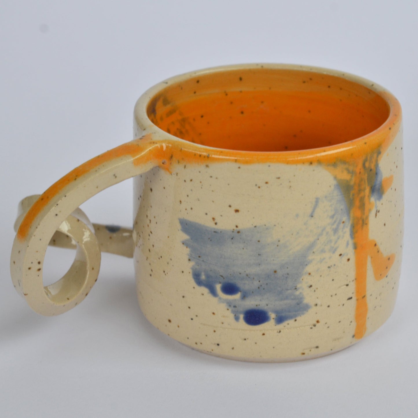 Handmade mug with a twisted handle for creative holding