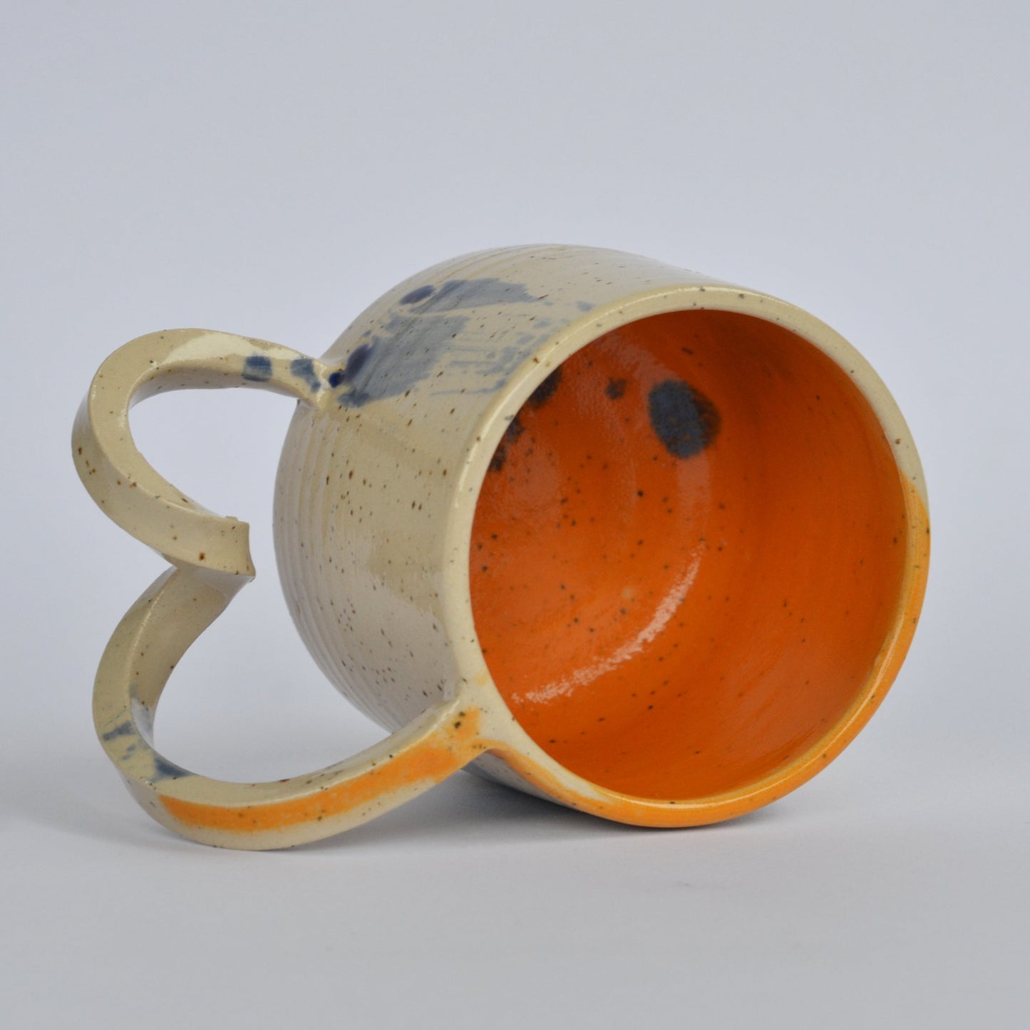 Handmade mug with a twisted handle for creative holding