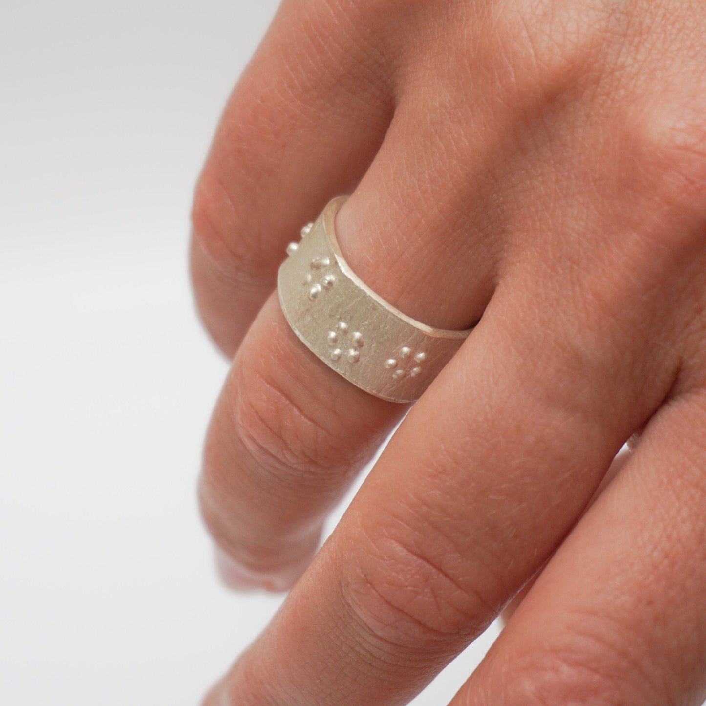 Handcrafted premium sterling silver ring with intricate dot detailing. Unique rough texture and artisanal craftsmanship