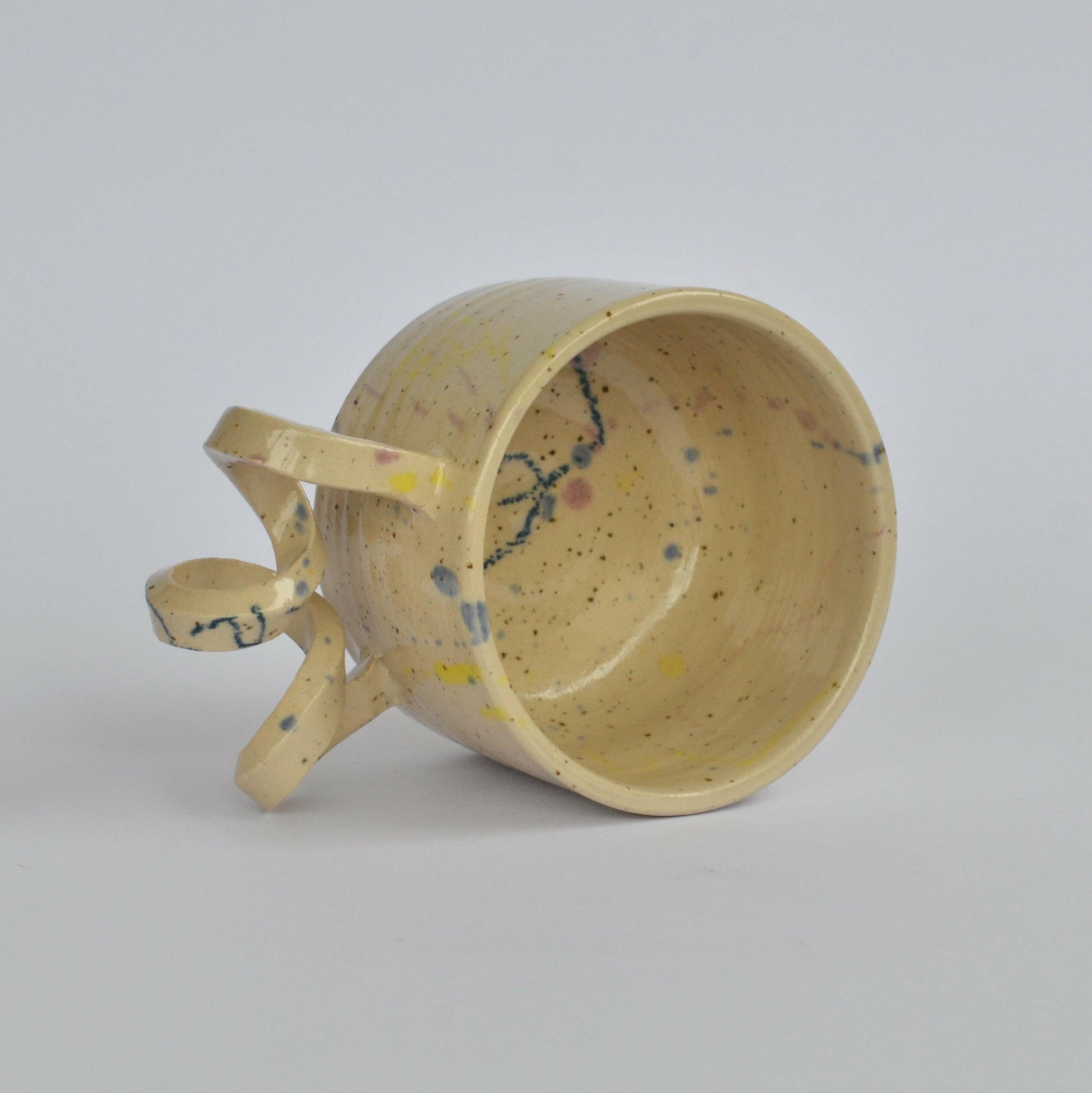 Handmade mug with a twisted handle for creative holding