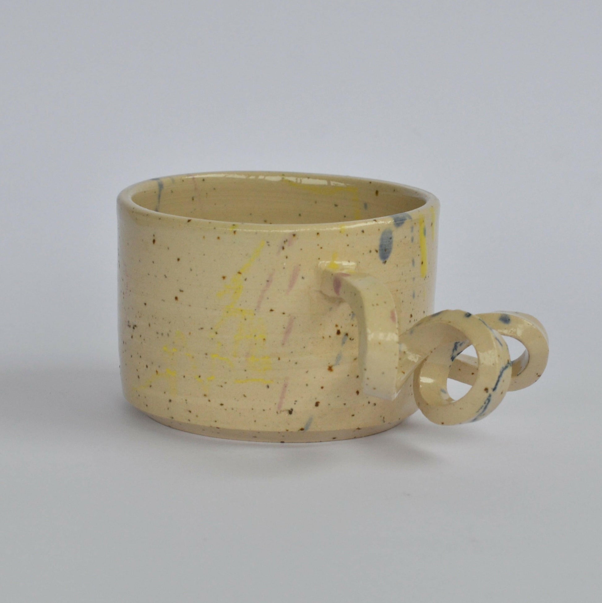 Handmade mug with a twisted handle for creative holding