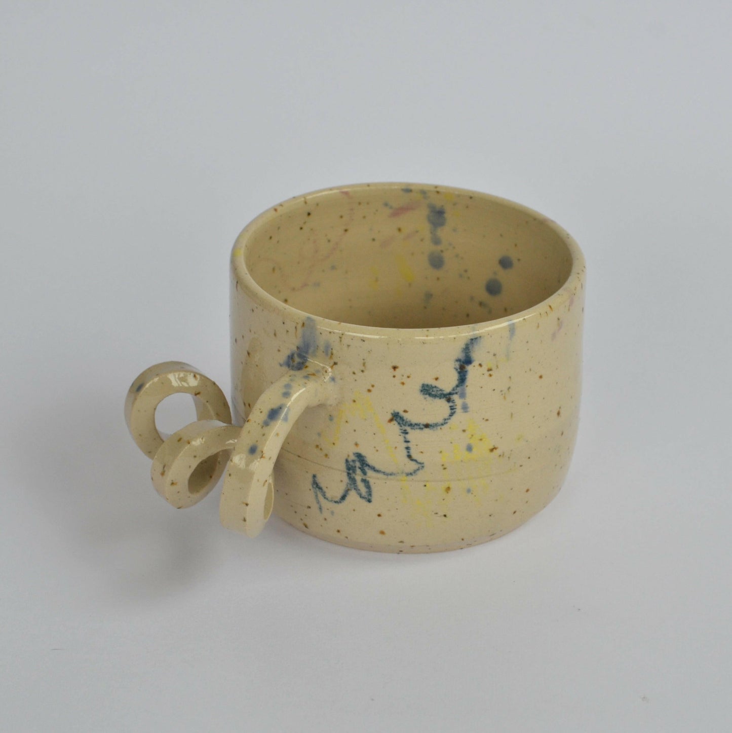 Handmade mug with a twisted handle for creative holding