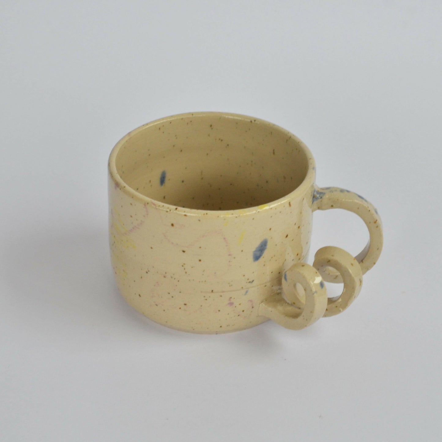 Handmade mug with a twisted handle for creative holding