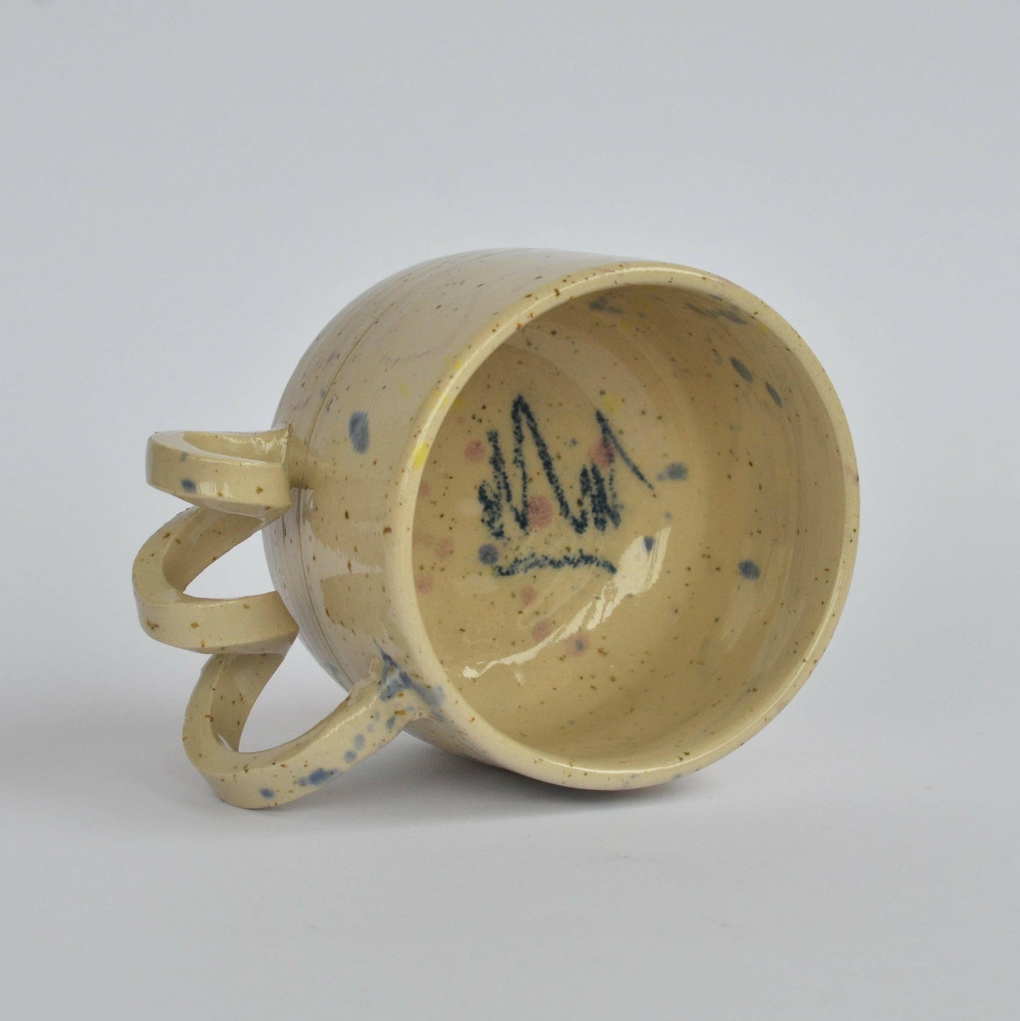 Handmade mug with a twisted handle for creative holding