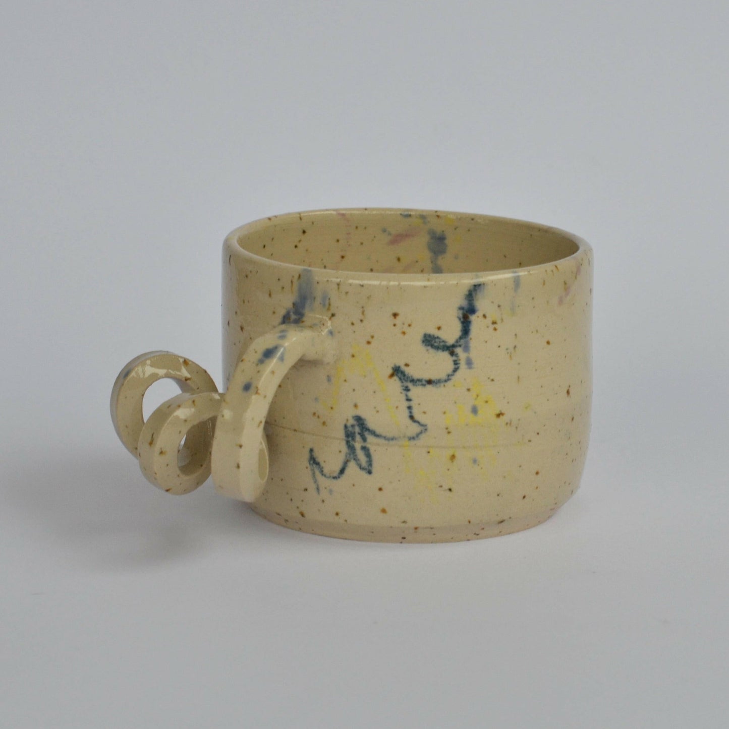 Handmade mug with a twisted handle for creative holding