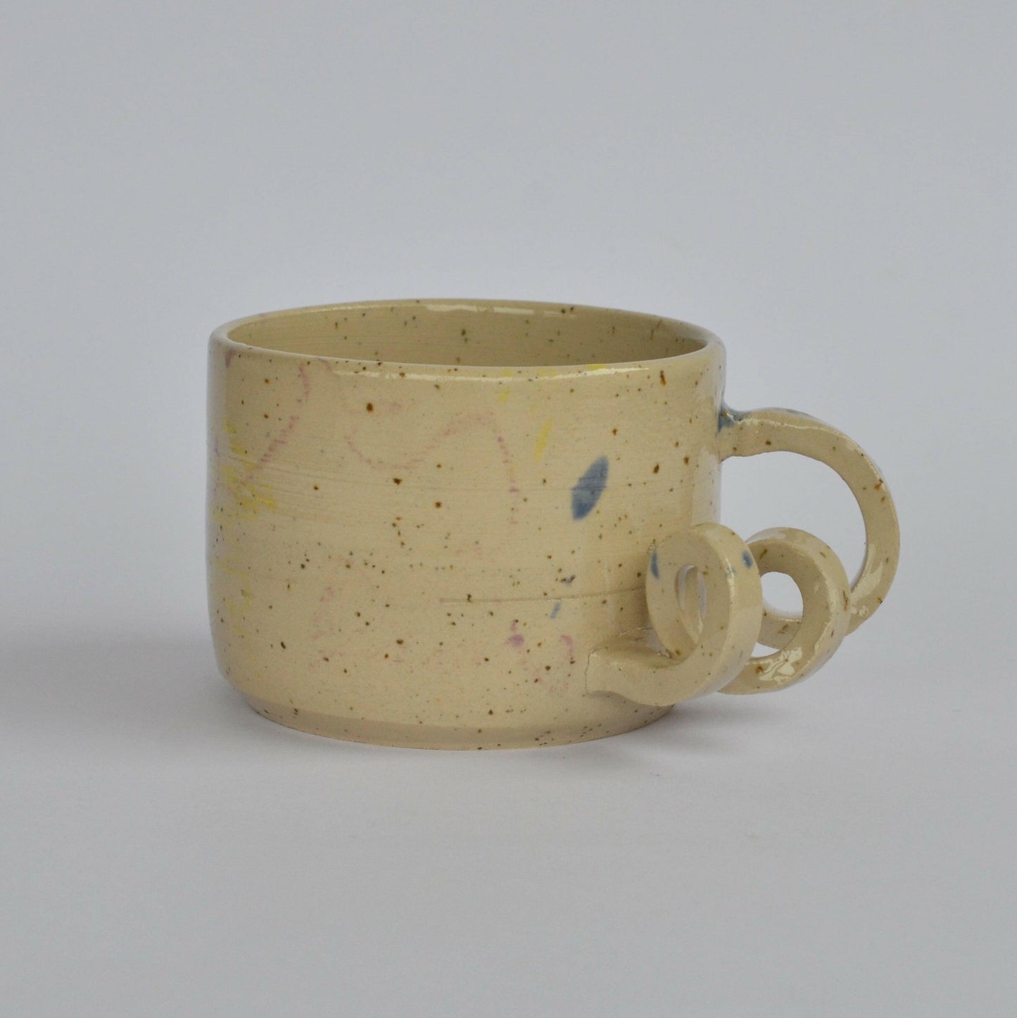 Handmade mug with a twisted handle for creative holding