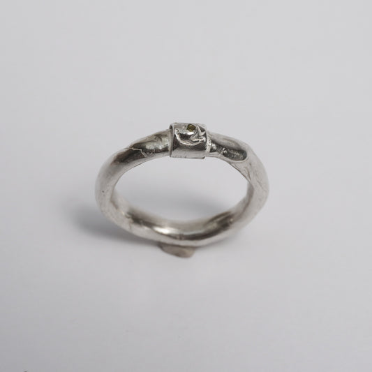 Artisanal handmade silver ring with sculptural organic band, featuring a central green zirconia stone. Unique one-of-a-kind design crafted in solid 925 sterling silver using the traditional lost-wax technique. Elegant, raw, slightly irregular surface with a minimal yet expressive form, created by a contemporary jewelry artist in Porto.