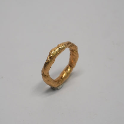 Handmade 24k gold-plated brass ring with a textured, slightly irregular surface. Cast using the lost-wax technique in a Porto-based studio. Unique, artisanal band with a minimal, handcrafted look.

