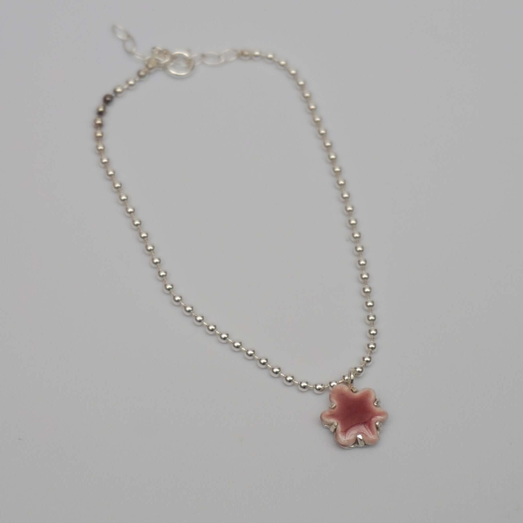 Silver bracelet with porcelain kindness pink pendant