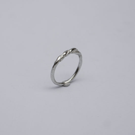 Handmade and unique sterling silver ring featuring a subtle, elegant twist design. Crafted using the traditional lost-wax casting technique, this artisanal piece reflects organic minimalism and slow design values. Made in a small studio in Porto, Portugal, the ring embodies natural imperfection and delicate craftsmanship in 925 silver.

