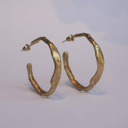Gold-plated handcrafted hoop earrings with organic irregular sculptural shape