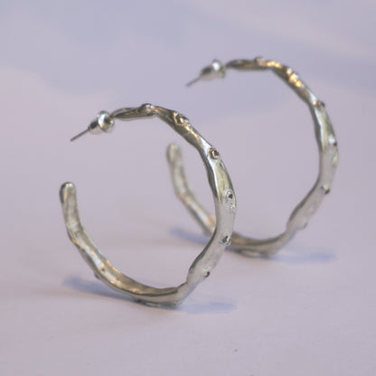 Silver handcrafted hoop earrings with organic irregular sculptural shape