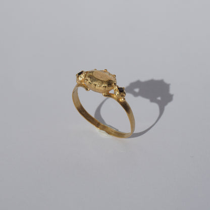 Handcrafted gold-plated ring with organic oval centerpiece and sculpted details
