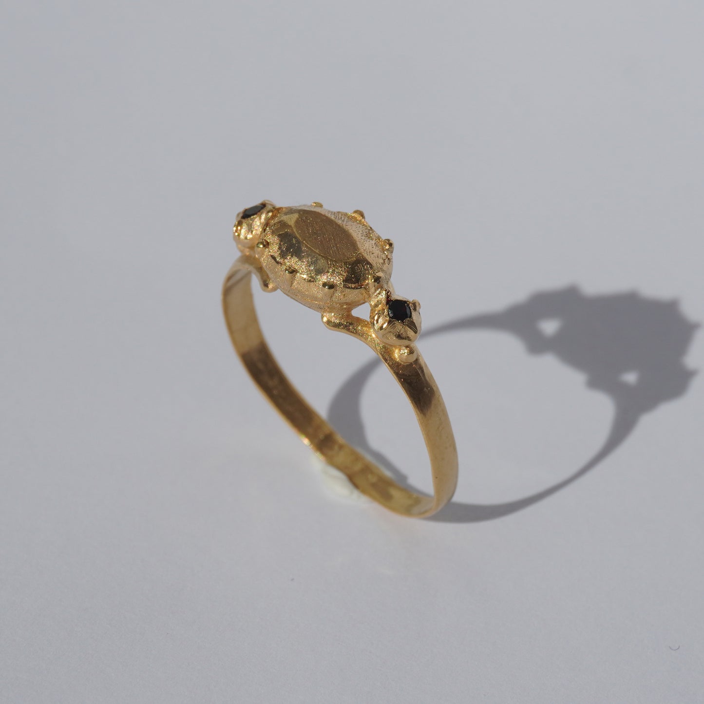 Handcrafted gold-plated ring with organic oval centerpiece and sculpted details