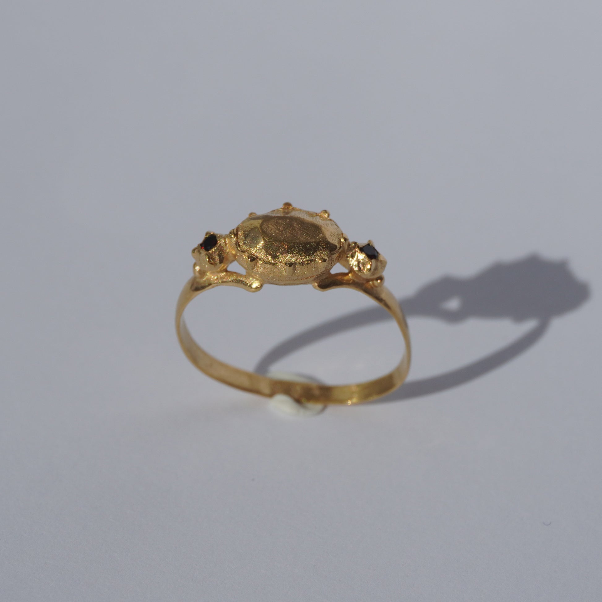 Handcrafted gold-plated ring with organic oval centerpiece and sculpted details