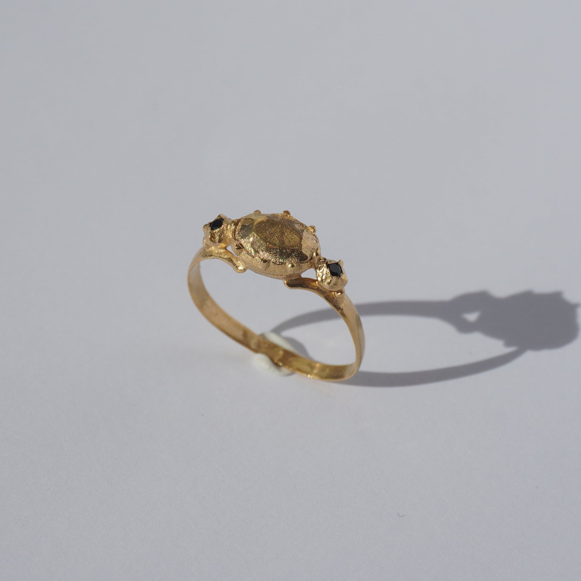 Handcrafted gold-plated ring with organic oval centerpiece and sculpted details