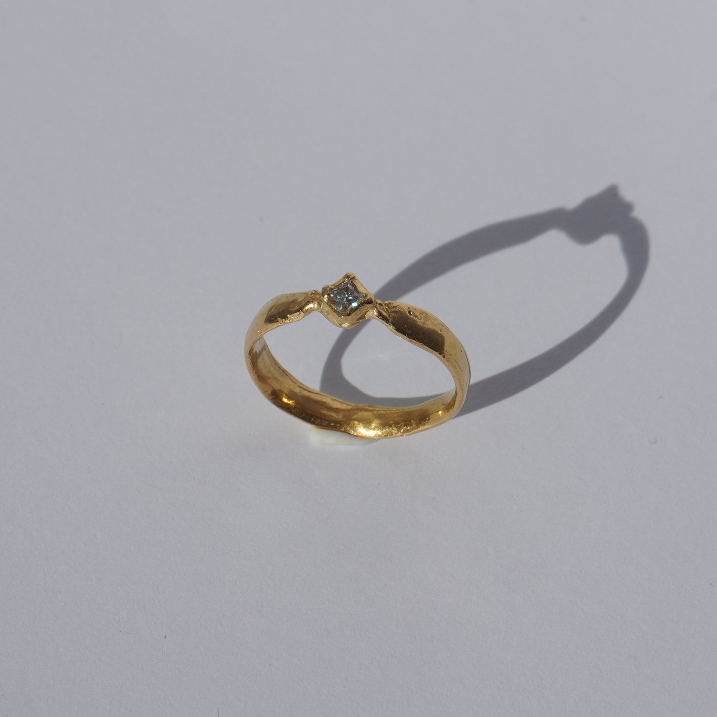 Handcrafted gold-plated ring with organic band and white gemstone