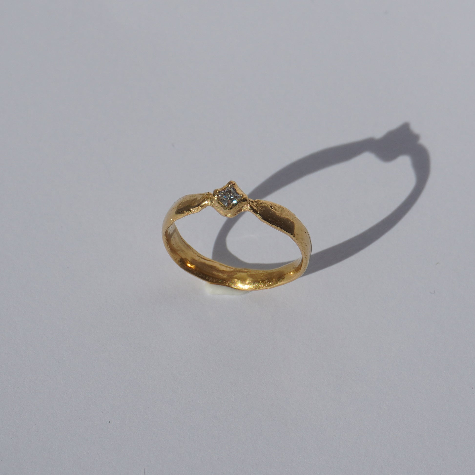 Handcrafted gold-plated ring with organic band and white gemstone