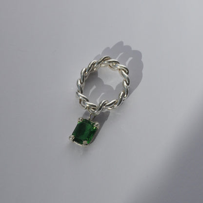 Handcrafted silver ring with twisted band and hanging emerald-cut green gemstone