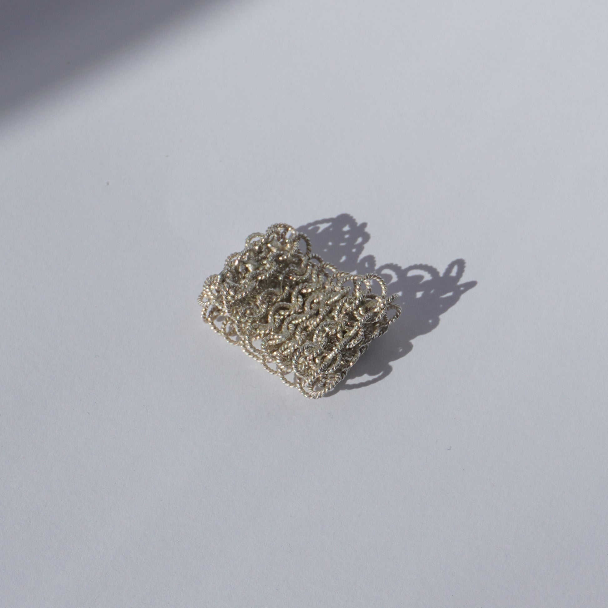 Handcrafted wide mesh ring made of interlinked twisted silver loops
